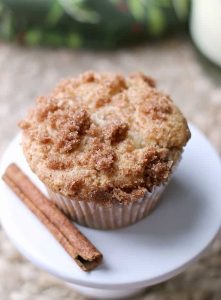 A 3 Ingredient Eggnog Snickerdoodle Muffin on a plate garnished with a cinnamon stick.