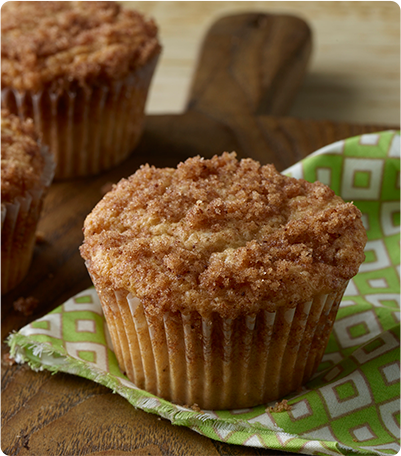 A Cinnamon Swirl Muffin on a retro-style green and white dish towel.