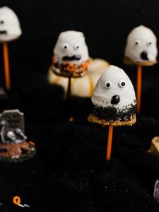 Multiple Spooky Ghost Pumpkin Spice Cake Pops with candy eyeballs.