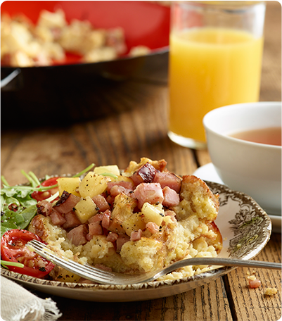 A plate full of Apple Ham Pancake Strata with garnish.