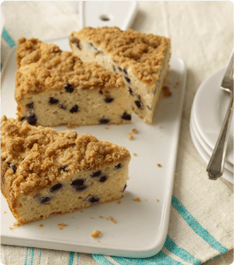Three slices of Blueberry Lemon Coffee Cake on a white platter.
