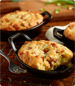 Three loaves of Country Brunch Cornbread in cast iron serving dishes.