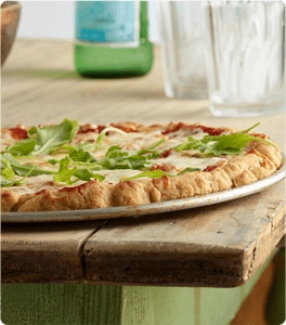 An Easy Gluten Free Pizza Crust on a pizza pan.