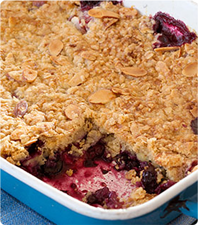 A Gluten Free Breakfast Berry Cobbler in a blue casserole dish.