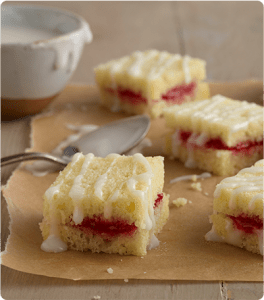 Several Lemon and Jam Tea Cakes on parchment paper.