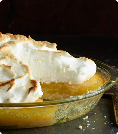 A Lemon Meringue Pie in a glass pie dish.