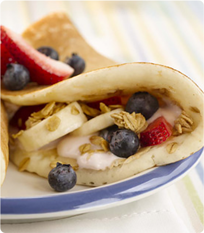 A Pancake Turnover filled with yogurt, granola, bananas, blueberries and strawberries.