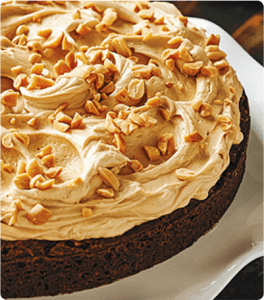 A Peanut Brownie Torte topped with a peanut butter frosting and chopped peanuts.