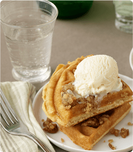 Praline Waffles a la Mode topped with chopped pecans.