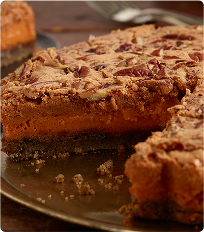 Pumpkin Pecan Bars pie with a slice cut out.