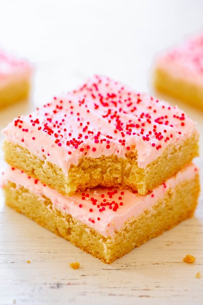 Two Valentine's Frosted Sugar Cookie Bars stacked.