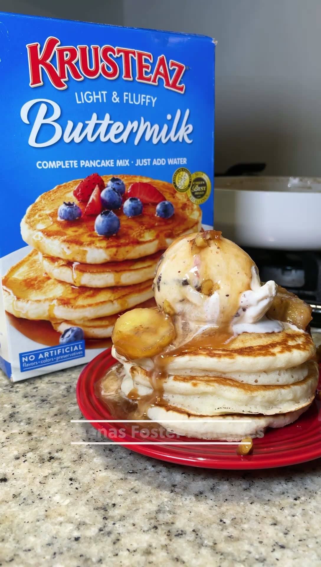 A stack of Bananas Foster Pancakes topped with ice cream and a spiced rum sauce.