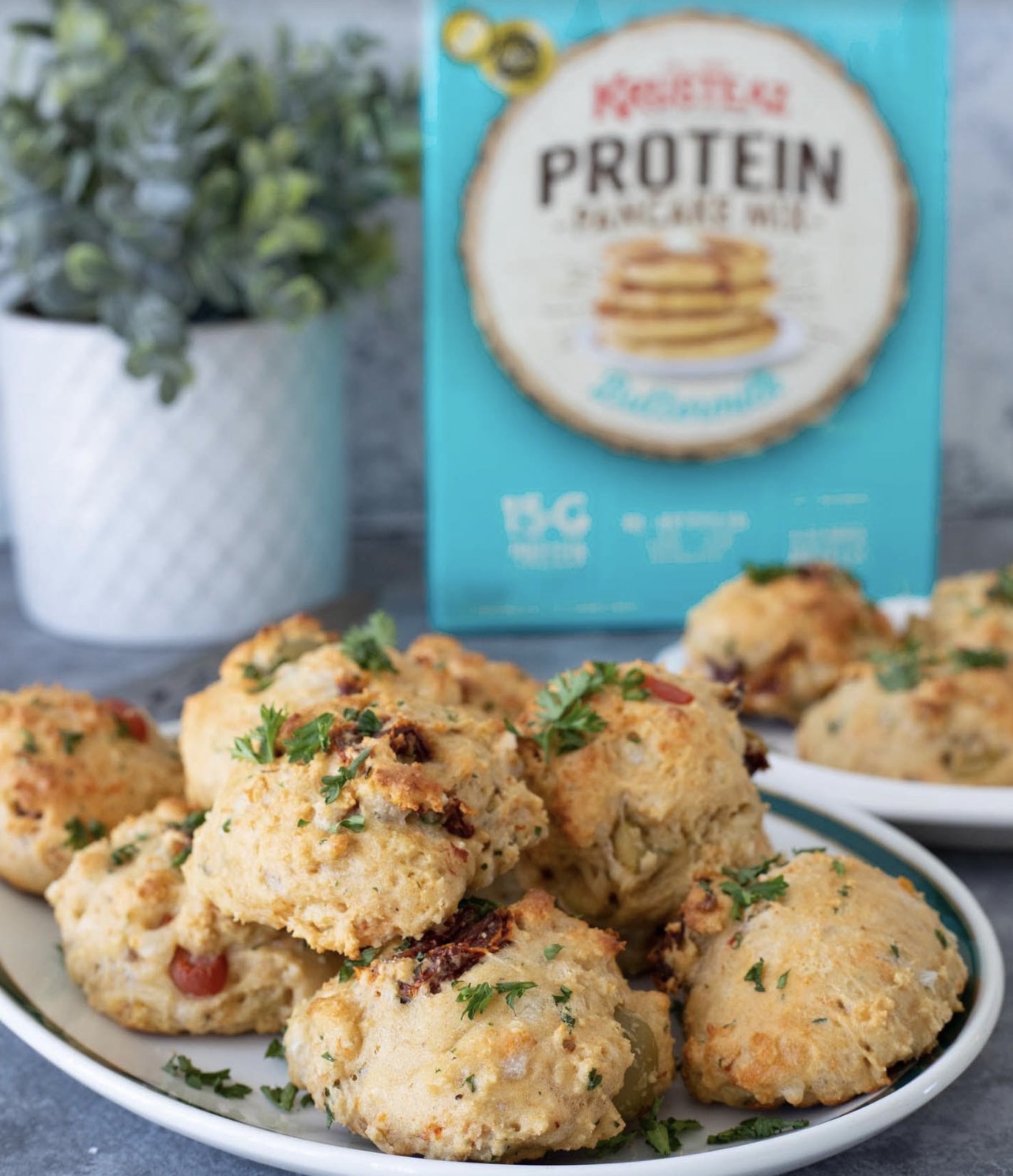 A plate of Mediterranean Drop Biscuits topped with chopped parsley.