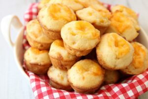 A basket of Cheesy Cornbread Muffins.