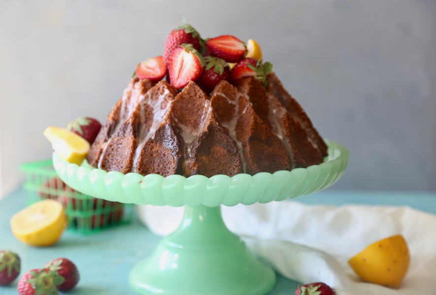 A Meyer Lemon Cream Cheese Bundt Cake on a cake stand.