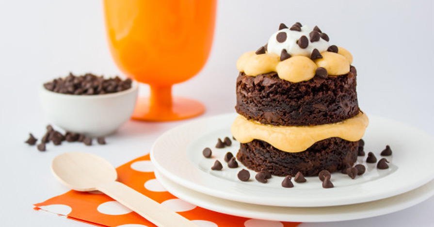 A plate of Gluten Free Pumpkin Brownie Stacks topped with whipped cream and chocolate chips.