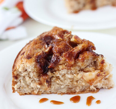 A slice of Caramel Apple Crumb Cake topped with caramel sauce.