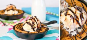 A Peanut Butter Skillet Cookie with a scoop of vanilla ice cream and drizzled with chocolate syrup.