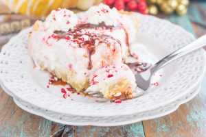 A slice of Peppermint Sugar Cookie Ice Cream Pie with a bite already taken out.