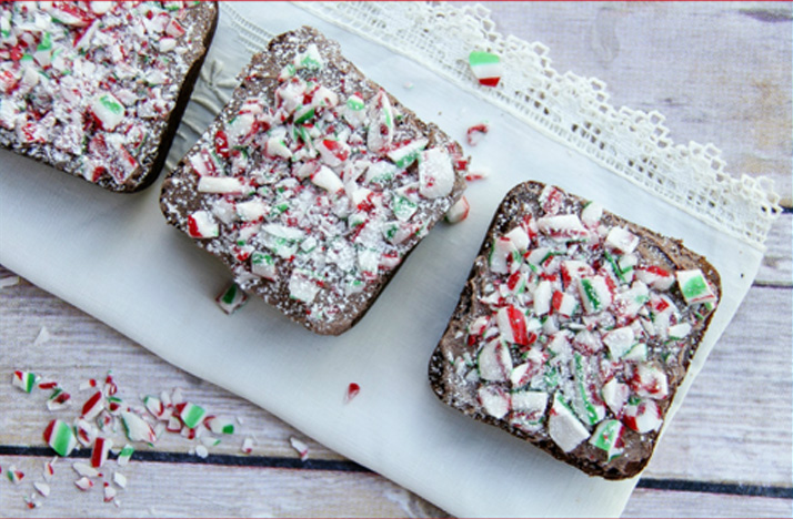 Three Gluten Free Peppermint Brownies on a white dish towel.