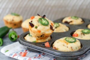 A muffin pan full of Spicy Cheddar Chorizo Cornbread Muffins.