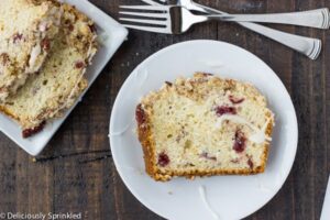 A slice of Streusel Cranberry Orange Bread on a plate.