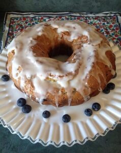 Victory Lap bundt cake topped with a glaze and fresh blueberries.