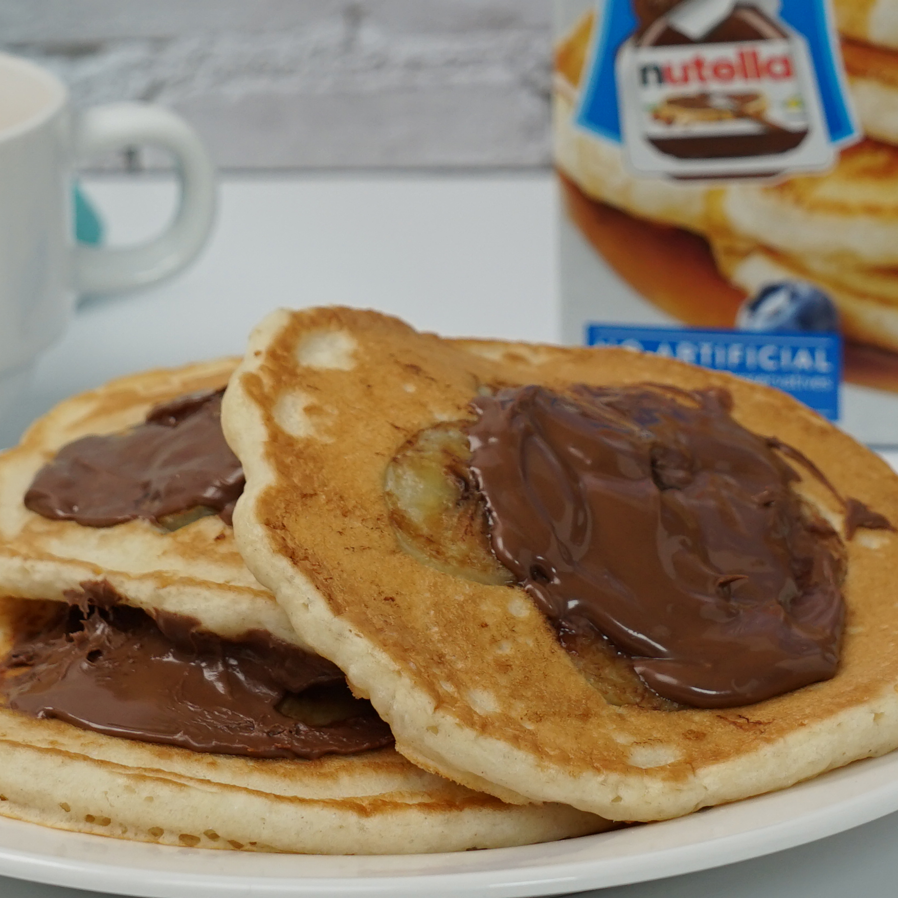 A stack of Sautéed Banana Pancakes with Nutella® Hazelnut Spread.