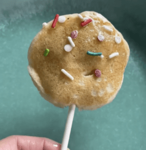 A Banana Pancake Lollipop topped with colorful sprinkles.