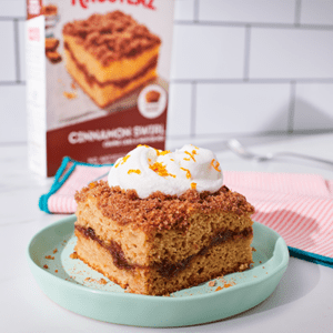 A slice of Spiced Chai Crumb Cake sits on a pale green plate.