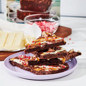 A stack of Gluten Free Brownie Brittle on a purple plate.