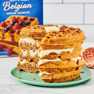 A Belgian Waffle Carrot Cake with a cream cheese frosting in between each waffle layer.