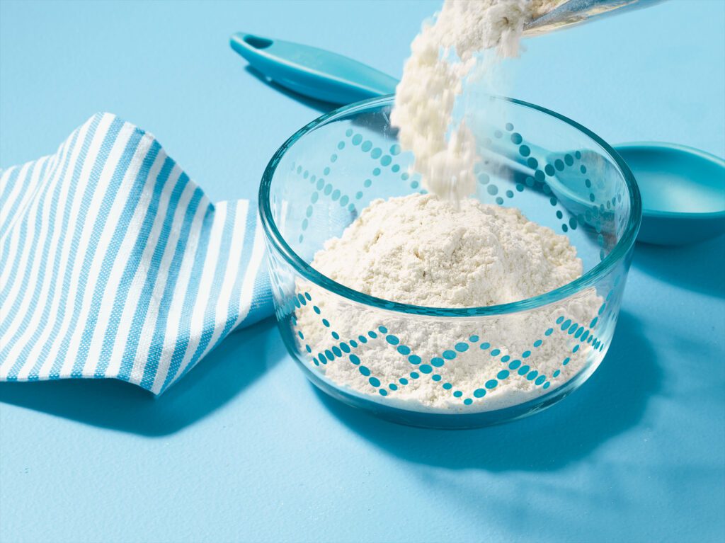 Flour being poured into a bowl